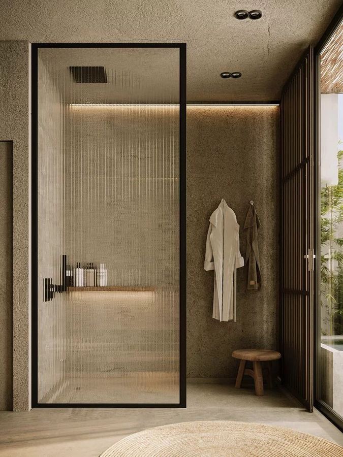 Spa-like bathroom with floor-to-ceiling reeded glass shower partition framed in slim blackened steel
