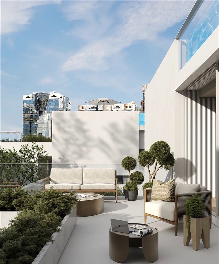 Urban rooftop terrace render with wood-frame sofa and armchair on cream cushions, two low round coffee tables with bronze bases, multiple sculpted spherical topiary trees, planters on elevated wood stands, light concrete pavers, Lisbon skyline in background